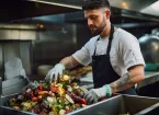 chef sorting out food waste in a kitchen