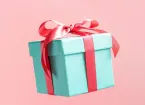 Gift - present wrapped in green paper with a red ribbon