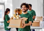 Group of volunteers carrying boxes of food 