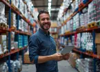 Person holding a clipboard in a warehouse 