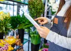 Florist looking at a digital device 