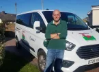 Trevor taylor standing in front of mini bus