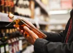 person buying alcohol in a supermarket 