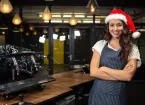 Coffee shop worker wearing a Christmas hat