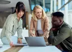 colleagues looking at a lap top 