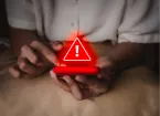 mobile phone and a warning sign in red 