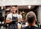 Barber - smiling cutting a customer's hair