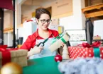 person wrapping Christmas presents 