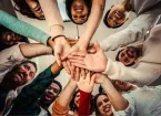 group of people touching hands 