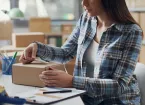 small business owner packaging parcels 