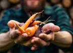 man holding carrots