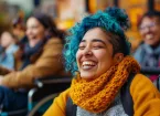 Wheelchair user - woman wearing a yellow scarf and hair dyed blue 