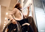 wheelchair user using an ID card to access an office 