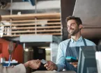 cafe worker taking payment from a customer 