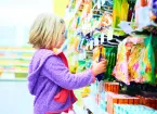 Child picking sweets in a supermarket 