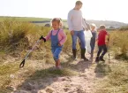 Family litter picking on a beach 