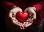 Hands holding a red love heart 