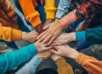 group of volunteers holding hands 