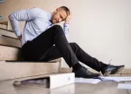 Office worker falling downstairs 