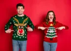 One person wearing a jumper with a Reindeer, another person wearing jumper with a Christmas tree