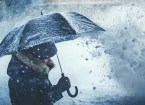 Person holding an umbrella in wintry weather