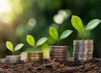 Piles of coins and plant shoots - business growth and investment 