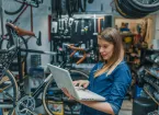 Young female mechanic with laptop. 