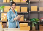  woman owner startup business look at camera work happy with box at home prepare parcel delivery in sme supply chain, procurement,