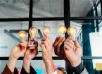Teamwork concept with business people holding lightbulbs