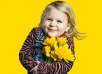 girl holding a bunch of daffodils