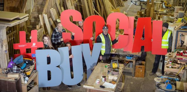 Reseiclo staff holding up big letters that spell #BUY SOCIAL