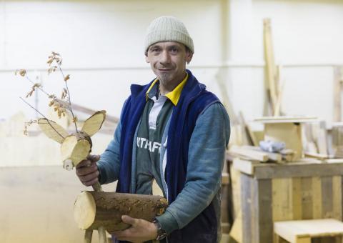 Man holding woodwork crafted reindeer