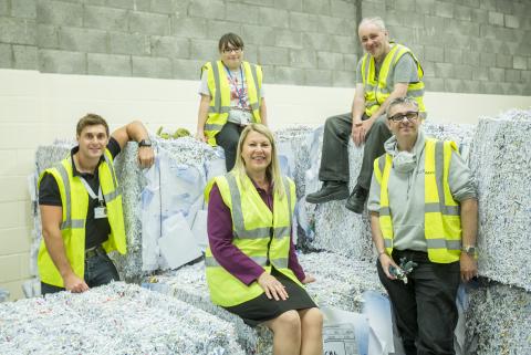 Workers with shredded paper