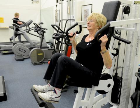 Woman on exercise machine at gym