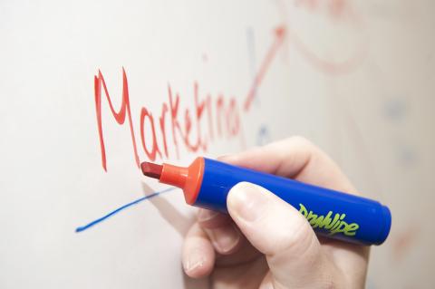 The word "Marketing" on whiteboard underlined