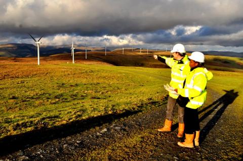 Two men maintaining a wind farm