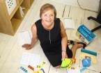 Jo Bold of 3D Learning Solutions sat on a floor with learning equipment.