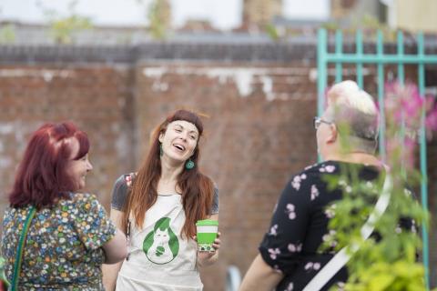 woman laughing with residents in playground