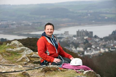 owner of climb wales Glyn sat on hillside