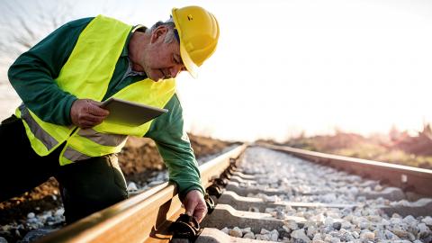 A man working a train track.