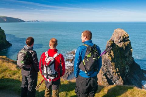 Three male walkers on Pembrokeshire / Wales Coast Path