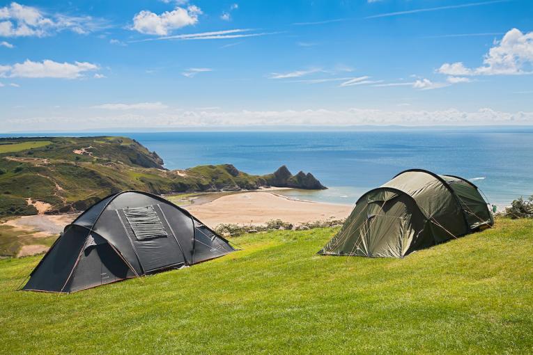 image of two tents overlooking three cliffs bay on the gower