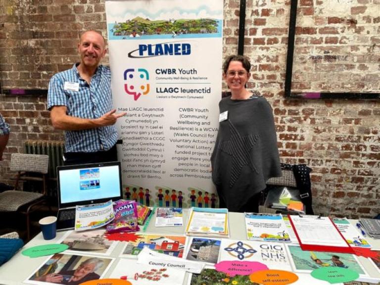 image of planed staff with banner and exhibition stand at youth event