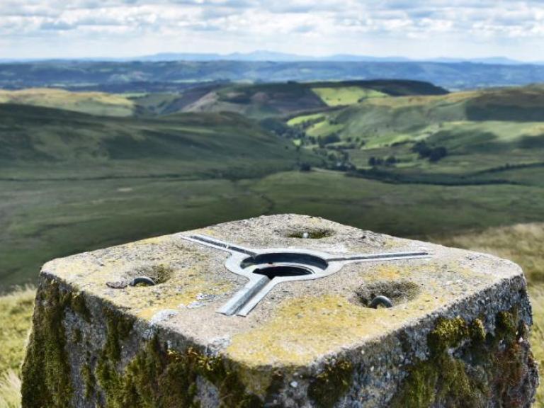 image of large compass on cambrian mountains
