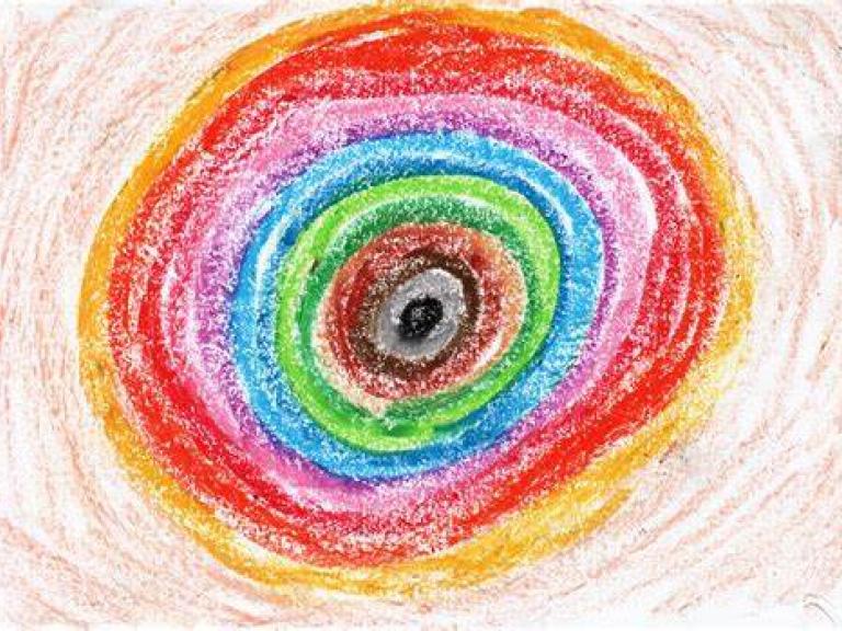child's drawing of different coloured circle using crayons