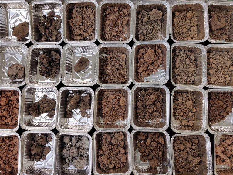 samples of soil in small foil containers